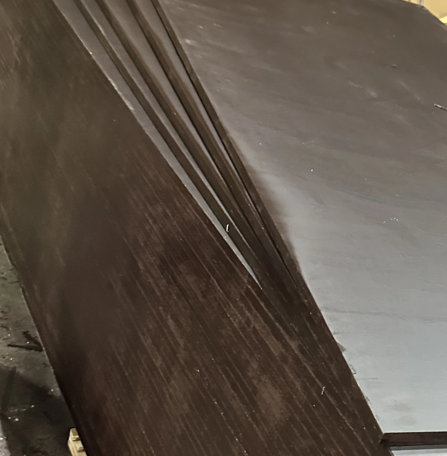 Corner of a stack of film-faced plywood with the top sheets fanned out