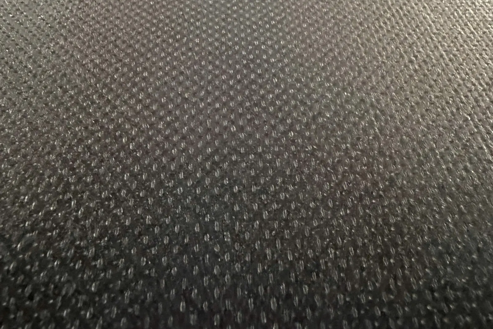 Close view of rice-grain anti-slip embossing on a dark film face