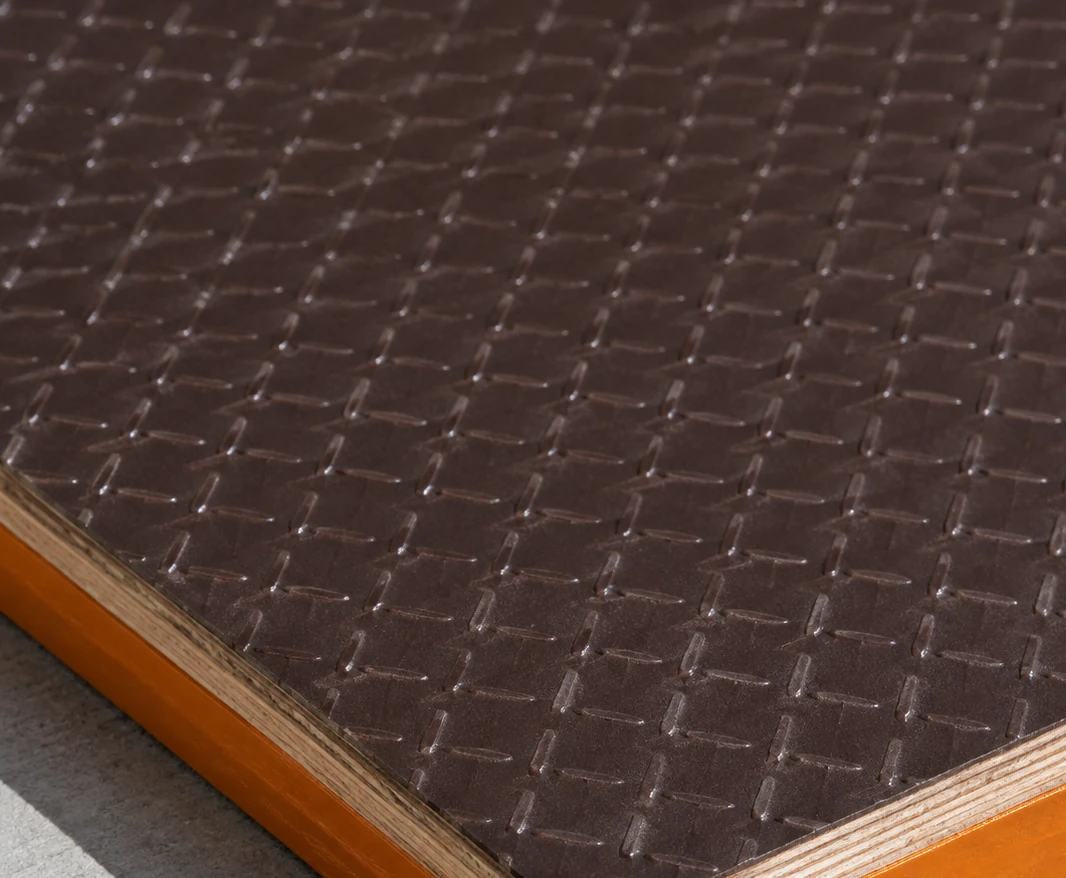 Dark brown film face embossed with a fine crossing wire-mesh pattern, an amber edge in the corner